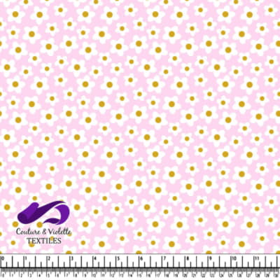 Pink fabric with small white daisies and yellow centers pattern